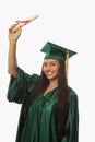 Female college graduate in cap and gown Royalty Free Stock Photo