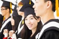 female college graduate at graduation with classmates Royalty Free Stock Photo