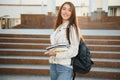 Female college student with books outdoors. Smiling school girl with books standing at campus. I'm prepared for exam Royalty Free Stock Photo