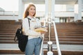 Female college student with books outdoors. Smiling school girl with books standing at campus. I'm prepared for exam Royalty Free Stock Photo