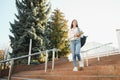 Female college student with books outdoors. Smiling school girl with books standing at campus. I'm prepared for exam Royalty Free Stock Photo