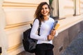 Female college student with books outdoors in the street. Smiling school girl with books standing at campus. Portrait of perfect Royalty Free Stock Photo