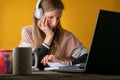 Female college student with headphones listening to a lecture online Royalty Free Stock Photo