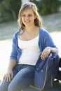 Female College Student Sitting On Bench With Book Royalty Free Stock Photo