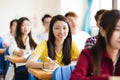 female college student sitting with classmates Royalty Free Stock Photo