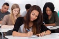 Female college student sitting in classroom Royalty Free Stock Photo