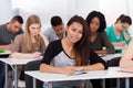 Female college student sitting at desk Royalty Free Stock Photo