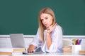 Female college student working on a laptop in classroom, preparing for an exam. Beautiful caucasian female student is Royalty Free Stock Photo