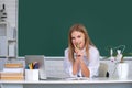 Female college student working on a laptop, preparing for an exam on school interior, college classroom, class in Royalty Free Stock Photo