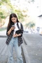 Female college students happily holding laptops outdoors after school on campus. when the sun goes down the horizon with Royalty Free Stock Photo