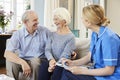 Female Community Nurse Visits Senior Couple At Home Royalty Free Stock Photo