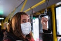 Female commuter wears a protective mask in public transport. Royalty Free Stock Photo