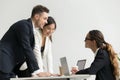 Confident female boss talking to subordinates