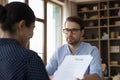 Female company leader, director, recruiter reviewing paper resume Royalty Free Stock Photo