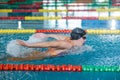 Female swimmer moving through the water performs a butterfly stroke Royalty Free Stock Photo