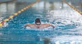 Female swimmer moving through the water performs a butterfly stroke Royalty Free Stock Photo