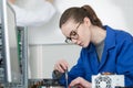 female computer engineer repairing computer motherboard