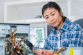 Female computer engineer repairing computer motherboard Royalty Free Stock Photo