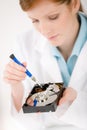 Female computer engineer - woman repair hard disc Royalty Free Stock Photo