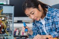 Female computer technician using soldering iron Royalty Free Stock Photo