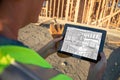 Female Construction Worker Reviewing Kitchen Drawing on Computer Royalty Free Stock Photo