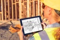 Female Construction Worker Reviewing Kitchen Drawing on Computer Royalty Free Stock Photo