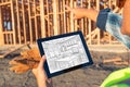 Female Construction Worker Reviewing Kitchen Drawing on Computer Royalty Free Stock Photo