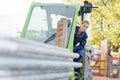 Female construction apprentice learning to drive heavy equipment