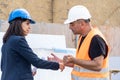 Female construction boss talking to a foreman