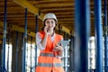 Female construction engineer. Architect with a tablet computer at a construction site. Young Woman looking, building Royalty Free Stock Photo