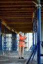 Female construction engineer. Architect with a tablet computer at a construction site. Young Woman looking, building site place on Royalty Free Stock Photo