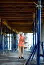 Female construction engineer. Architect with a tablet computer at a construction site. Young Woman looking, building site place on Royalty Free Stock Photo