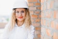 Female construction engineer. Architect with a tablet computer at a construction site. Young Woman looking, building Royalty Free Stock Photo