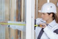 Female construction installing window i Royalty Free Stock Photo