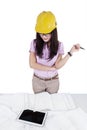 Female construction specialist looking at blueprints Royalty Free Stock Photo