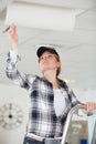 female construction worker assembling suspended ceiling Royalty Free Stock Photo