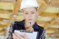 Female construction worker with clipboard