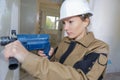 Female construction worker drilling concrete wal Royalty Free Stock Photo
