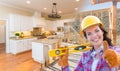 Female Construction Worker In Front of House Framing Gradation