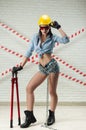 female construction worker in a hard hat with a bolt cutter in his hands Royalty Free Stock Photo