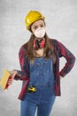 Female construction worker holding sandpaper