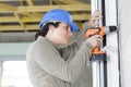 female construction worker holding screwdriver handtool and cordless screwdriver