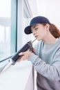 Female construction worker installing window in house Royalty Free Stock Photo