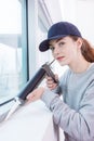female construction worker installing window in house Royalty Free Stock Photo