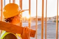 Female Construcion Worker Looking Out From New Home Framing Royalty Free Stock Photo