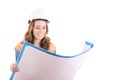 Female construction worker reading blue prints