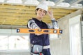 female construction worker showing spirit level Royalty Free Stock Photo