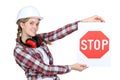 Female construction worker with sign