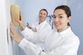 female construction worker smoothing wall surface