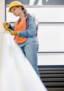 Female construction worker taking measurement